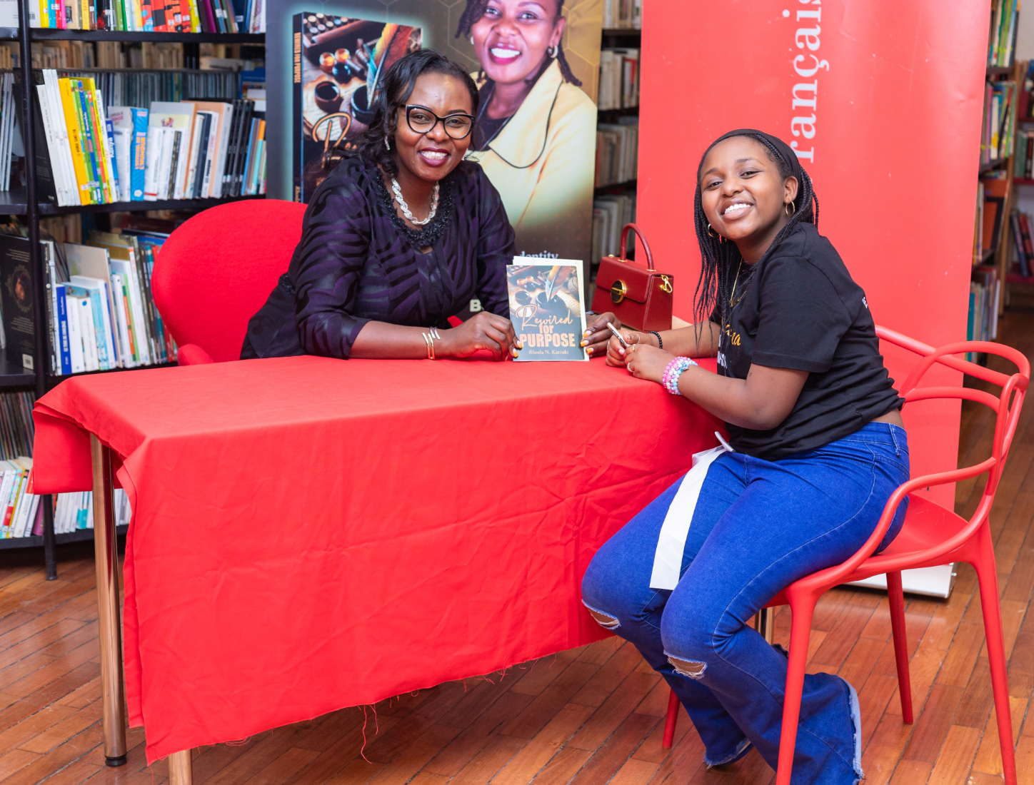 Rhoda Kariuki holding Rewired for Purpose Book